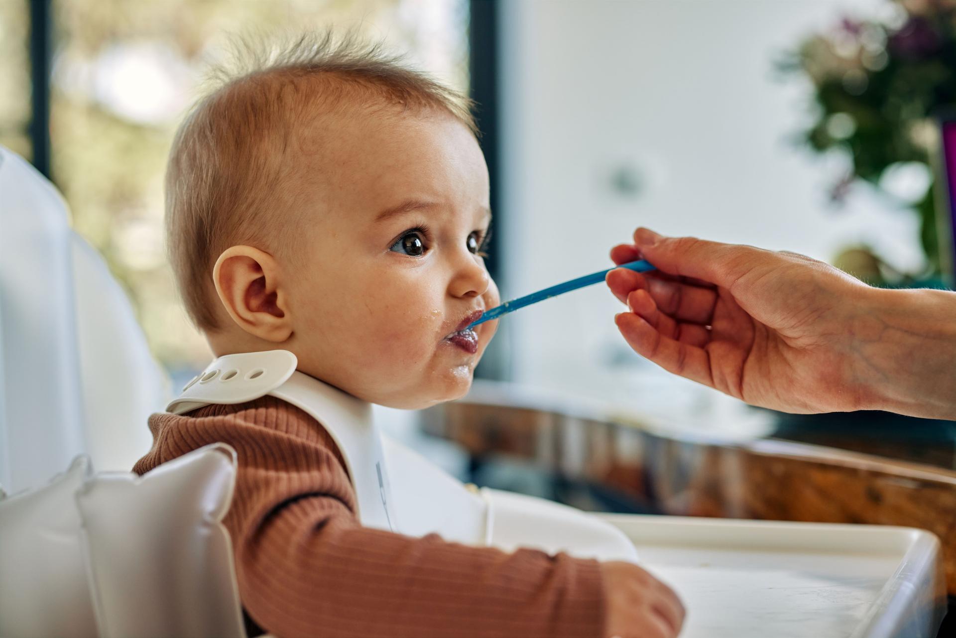 Adorable baby boy during lunchtime